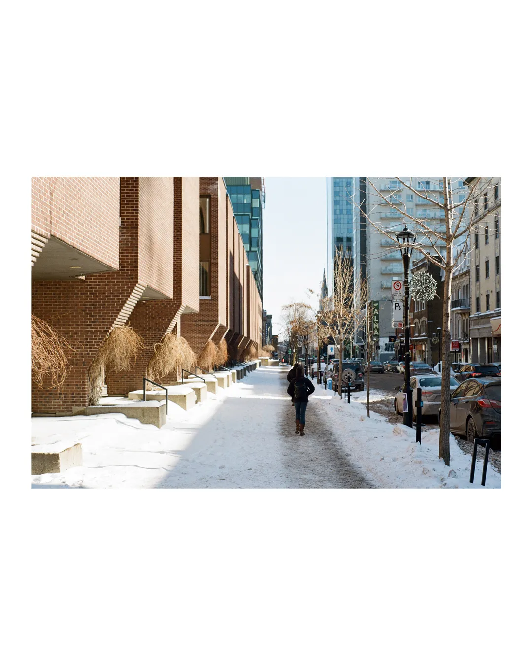 person walking on snowy sidewalk